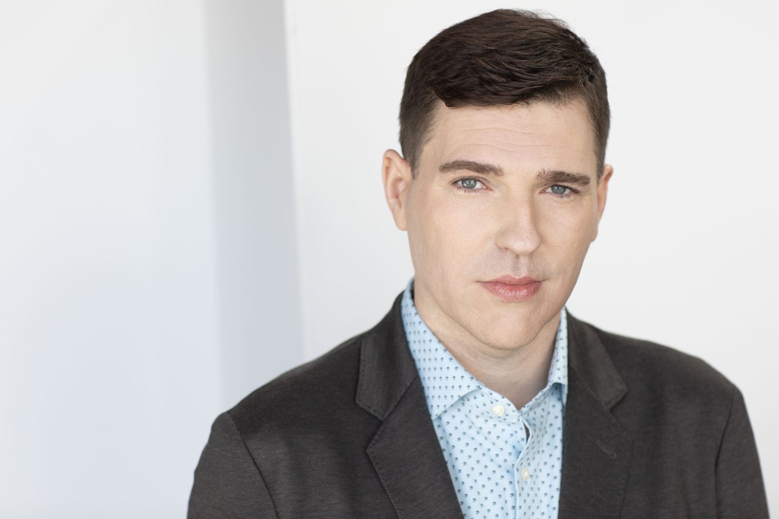Wide headshot in a grey blazer